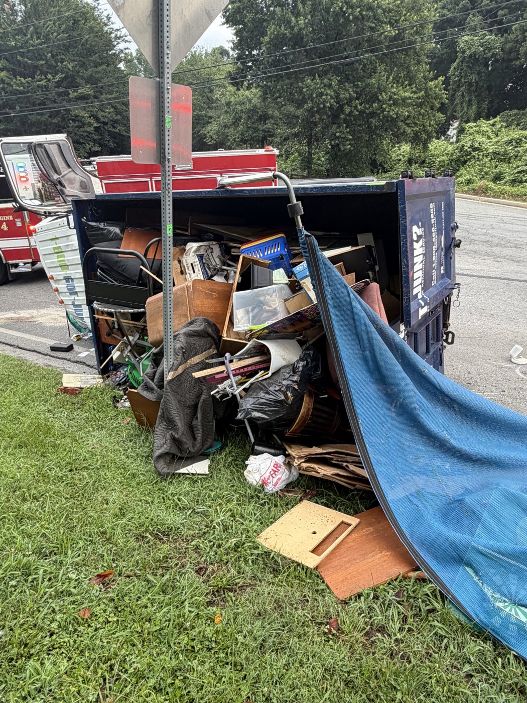 Spilled junk load and fire engine at the scene
